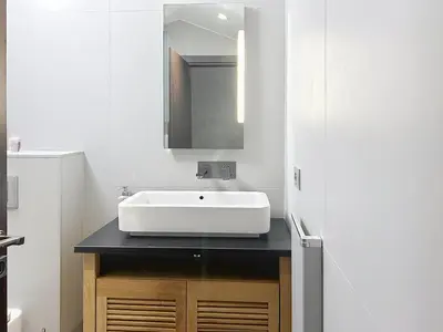 a bathroom with a white sink and a refrigerator at Hoche in Cannes