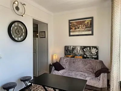 a living room with a couch and a table at Studio coeur de Cannes 318L in Cannes