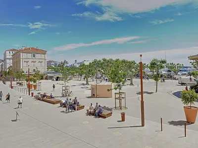 a group of people sitting on benches in a plaza at Studio coeur de Cannes 318L in Cannes