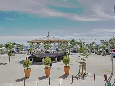 a gazebo with potted plants in a parking lot at Studio coeur de Cannes 318L in Cannes