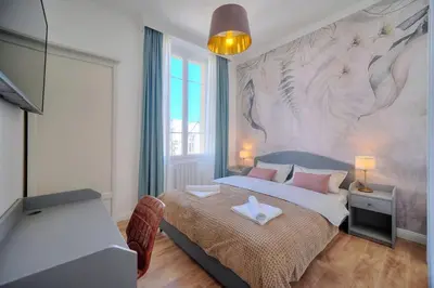 a bedroom with a large bed with a mural on the wall at Oasis du Sud 4 beds and 4 baths 10 min from Palais in Cannes