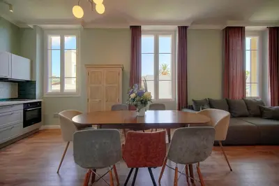 a living room with a table and chairs and a couch at Oasis du Sud 4 beds and 4 baths 10 min from Palais in Cannes
