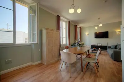 a living room with a table and chairs and a couch at Oasis du Sud 4 beds and 4 baths 10 min from Palais in Cannes