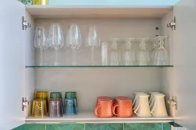 a bunch of glass vases sitting on a shelf at Oasis du Sud 4 beds and 4 baths 10 min from Palais in Cannes