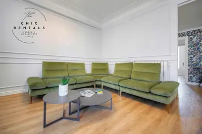 a living room with green couches and a table at SEA PEARL Luxury apartament by the Croisette and the beach in Cannes