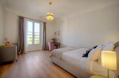 a bedroom with a bed and a large window at SEA PEARL Luxury apartament by the Croisette and the beach in Cannes