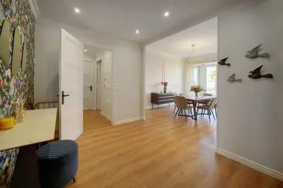 a living room with a table and a dining room at SEA PEARL Luxury apartament by the Croisette and the beach in Cannes