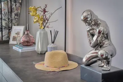 a table with a hat and some vases andartifacts at Serenity by the Sea 180 Degrees Sea View and Pool in Cannes