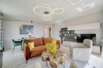 a living room with a couch and a table at Serenity by the Sea 180 Degrees Sea View and Pool in Cannes