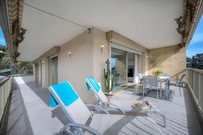 a balcony with chairs and a table on a house at Serenity by the Sea 180 Degrees Sea View and Pool in Cannes