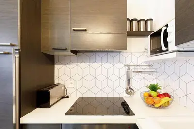a kitchen with a bowl of fruit on a counter at Charmant studio près de la mer in Cannes