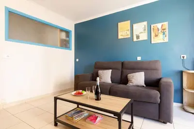 a living room with a couch and a table at Charmant studio près de la mer in Cannes
