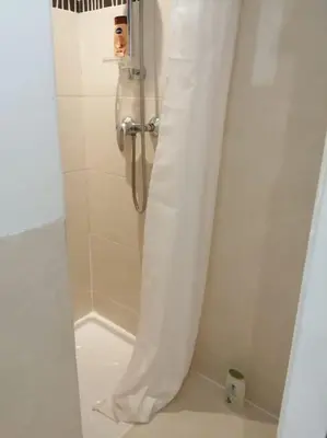 a shower with a shower curtain in a bathroom at Charmant studio près de la mer in Cannes