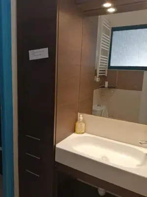 a bathroom with a sink and a mirror at Charmant studio près de la mer in Cannes
