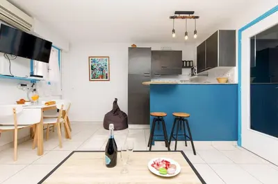 a kitchen with a table with a plate of food on it at Charmant studio près de la mer in Cannes