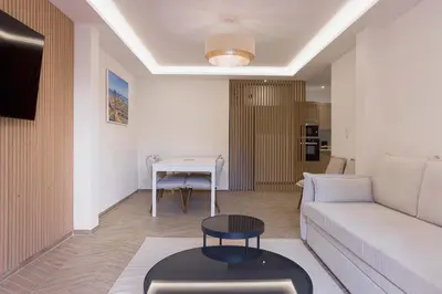 a living room with a couch and a table at Palais Carthage - 10 mn à pied du palais, Centre, Balcon in Cannes
