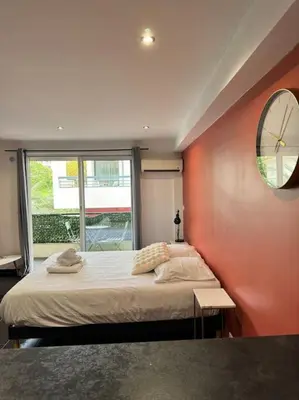 a bedroom with a large bed and a mirror at Grand Studio Centre Cannes in Cannes