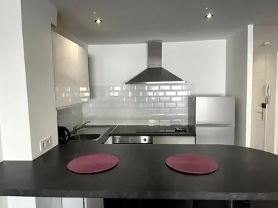 a kitchen with two red mats on a counter at Grand Studio Centre Cannes in Cannes