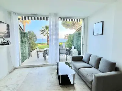 a living room with a couch and a view of the ocean at Château de la mer, by Welcome to Cannes in Cannes