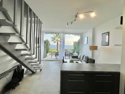 a kitchen and living room with a spiral staircase at Château de la mer, by Welcome to Cannes in Cannes