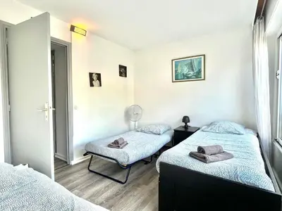 a bedroom with two beds and a mirror at Château de la mer, by Welcome to Cannes in Cannes