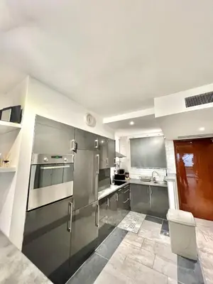 a large kitchen with stainless steel appliances at Château de la mer, by Welcome to Cannes in Cannes