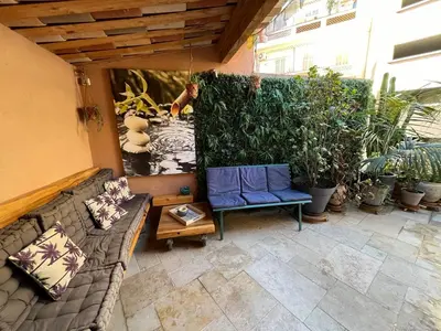 an outdoor patio with a couch and some plants at Residence Sao Jorge in Cannes
