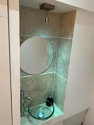 a bathroom with a mirror and a sink at Residence Sao Jorge in Cannes