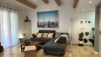 a living room with a couch and a large window at Residence Sao Jorge in Cannes