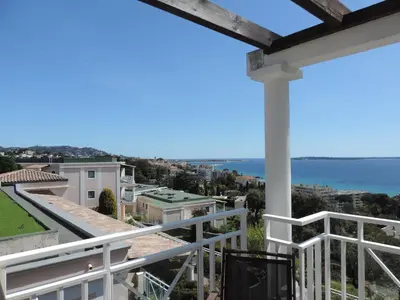 a view of the ocean from the balcony of a house at Stunning condo with SEA VIEW Balcony & SWIMMING POOL in Cannes