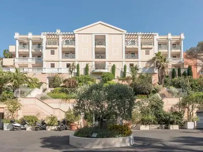 a large building with a tree in front of it at Stunning condo with SEA VIEW Balcony & SWIMMING POOL in Cannes