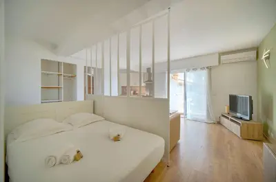 a bedroom with a bed with two stuffed animals on it at Studio Moderne BALCON, proche FORVILLE- CENTRE CANNES A0B198 in Cannes