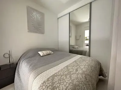 a bedroom with a bed and a large mirror at 2P proche mer sib06 in Cannes