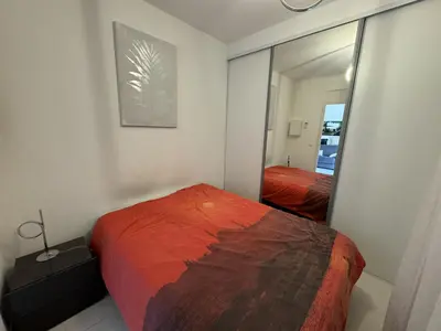 a bedroom with a bed and a mirror at 2P proche mer sib06 in Cannes