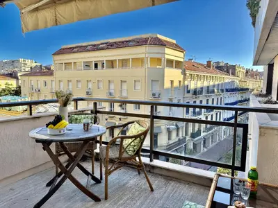 a table and chairs on a balcony with a view at Belle terrasse apercu mer NAF568 in Cannes
