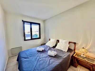 a bedroom with a bed with two towels on it at Belle terrasse apercu mer NAF568 in Cannes