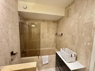 a bathroom with a tub and a shower and a sink at Belle terrasse apercu mer NAF568 in Cannes