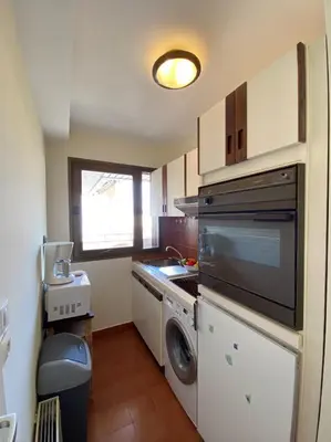 a kitchen with a sink and a washing machine at Belle terrasse apercu mer NAF568 in Cannes