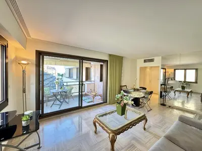a living room with a couch and a table at Belle terrasse apercu mer NAF568 in Cannes