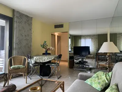 a living room with a couch and a table at Belle terrasse apercu mer NAF568 in Cannes