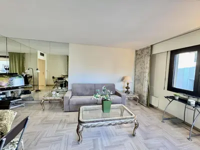 a living room with a couch and a tv at Belle terrasse apercu mer NAF568 in Cannes