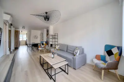 a living room with a couch and a table at Moderne 2 chambres TERRASSE, MARTINEZ CARLTON A2B249 in Cannes
