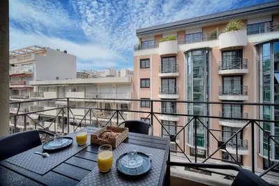 a table on a balcony with a view of a building at Moderne 2 chambres TERRASSE, MARTINEZ CARLTON A2B249 in Cannes