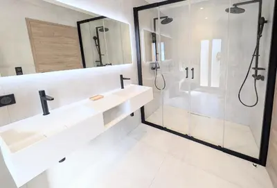 a white bathroom with two sinks and a shower at Ref VCLAIR by Palmes dProperties in Cannes