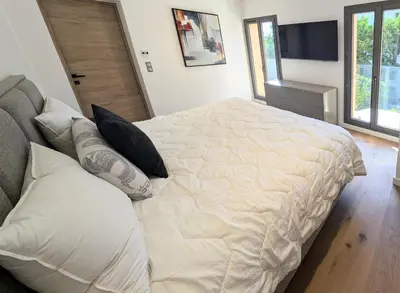a bedroom with a large bed and a television at Ref VCLAIR by Palmes dProperties in Cannes