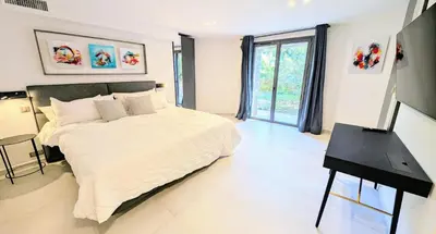 a bedroom with a bed and a desk in it at Ref VCLAIR by Palmes dProperties in Cannes
