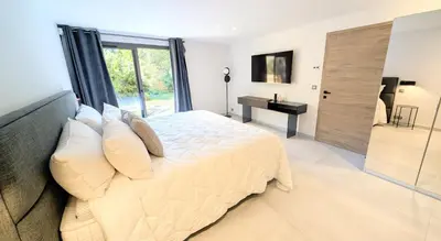 a bedroom with a large bed and a desk at Ref VCLAIR by Palmes dProperties in Cannes