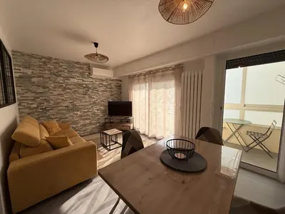 a living room with a couch and a table at SINT Cannes T 1 in Cannes