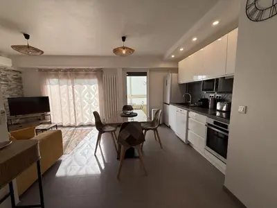 a kitchen with a table and chairs in a room at SINT Cannes T 1 in Cannes