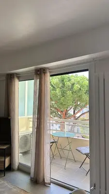 a sliding glass door with a view of a patio at SINT Cannes T 1 in Cannes